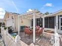Covered patio with seating area, providing a shaded spot for relaxation at 17744 Se 95Th Ct, Summerfield, FL 34491