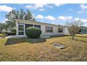 Back exterior view with screened porch and yard at 2001 Cristo Rd, Lady Lake, FL 32159