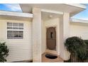 Front entrance with brick columns, screen door, and landscaping at 21837 Royal St Georges Ln, Leesburg, FL 34748