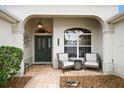 Inviting front porch featuring seating, decorative door with glass, and charming accents at 2709 Astoria Ave, The Villages, FL 32162