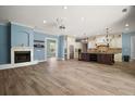 Bright open-concept living area with wood floors, fireplace, and kitchen at 29319 Old Mill E, Tavares, FL 32778