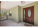 Welcoming covered front porch with decorative front door to the residence at 3380 Cr 528, Sumterville, FL 33585
