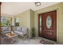 Welcoming covered front porch featuring seating for relaxing and enjoying the outdoors at 3380 Cr 528, Sumterville, FL 33585