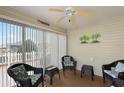 Cozy screened porch with wicker furniture and ceiling fan at 3764 Ivey Ter, The Villages, FL 32163