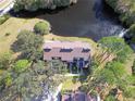 Aerial view of a condo complex situated by a lake, surrounded by lush greenery at 4668 Tower Pine Rd # Ge, Orlando, FL 32839