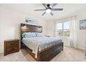 Bedroom with a wooden bed frame, nightstands, and ceiling fan at 4861 Panga Ave, Mount Dora, FL 32757