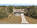 House in a wooded neighborhood with a long driveway at 51 Aspen Rd, Ocala, FL 34480