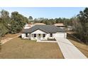 Aerial view of a single story home with a large driveway at 51 Aspen Rd, Ocala, FL 34480