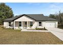 Newly built single story home with a gray roof and white siding at 51 Aspen Rd, Ocala, FL 34480