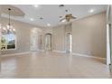 Spacious living room with tile floors, a ceiling fan, and chandelier at 6027 Spinnaker Loop, Lady Lake, FL 32159