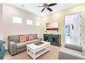 Cozy living room featuring a sofa, chairs, coffee table, and a TV at 8059 Knee Deep Rd, Kissimmee, FL 34747