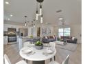 Open-concept living space with kitchen, dining area, and comfortable living room featuring modern décor at 8338 Se 178Th Deveaux Ln, The Villages, FL 32162