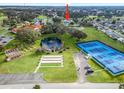 Community view showing home, tennis courts, and pond at 9897 Se 178Th Pl, Summerfield, FL 34491