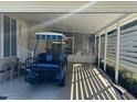 Covered carport with golf cart and screened enclosure at 114 Chestnut St, Leesburg, FL 34748