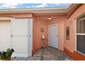 Inviting front entryway with terracotta tile flooring and sun-shaped wall art at 1504 Aalto Pl, The Villages, FL 32159