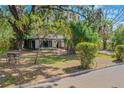 Landscaped front yard with lush greenery and oak trees at 1625 Virginia Dr, Clermont, FL 34711