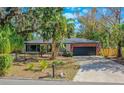 Well-maintained single-story home featuring a brick accent wall and a two-car garage with a large driveway at 1625 Virginia Dr, Clermont, FL 34711