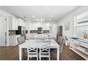 Kitchen dining area with white table and gray chairs at 17442 Blazing Star Cir, Clermont, FL 34714