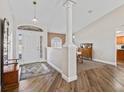 Inviting foyer featuring wood floors, a decorative pillar, and natural light at 17525 Se 121St Cir, Summerfield, FL 34491