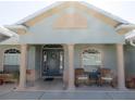 Inviting covered front porch featuring classic columns and seating area at 17525 Se 121St Cir, Summerfield, FL 34491