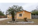 Orange house with palm trees and landscaping at 1906 Nancy Ann Ter, Ocoee, FL 34761