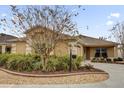 Charming single-story home featuring a well-manicured lawn and landscaped front yard with decorative rocks and plants at 1941 Loadstar Ave, The Villages, FL 32162