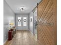 Inviting entryway featuring tile floors and a rustic barn door at 2064 Lula Rd, Minneola, FL 34715