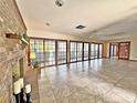 Bright Gathering room featuring tile floors, a brick fireplace, and sliding glass doors at 208 First St, Tavares, FL 32778