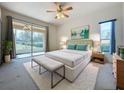 Bright bedroom with king bed and sliding glass doors to patio at 2289 Twickingham Ct, Clermont, FL 34711