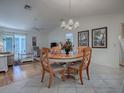 Dining room with wood table and chandelier at 2371 Wilson Way, The Villages, FL 32162