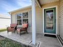 Small front porch with two wicker chairs at 2371 Wilson Way, The Villages, FL 32162