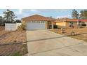 Inviting single-story home featuring an attached two-car garage and concrete driveway at 2385 Sw 159Th Ln, Ocala, FL 34473