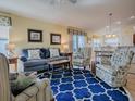 Living room with blue and yellow coastal decor and wood floors at 2549 Buttonwood Run, The Villages, FL 32162