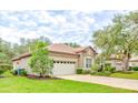 One-story house with a two-car garage and manicured lawn at 25921 San Rafael Ct, Howey In The Hills, FL 34737