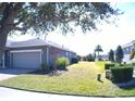 Single-story home with gray exterior and landscaping at 314 Salt Marsh Ln, Groveland, FL 34736