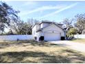 Two-story house with a fenced yard and driveway at 33025 Jodee Ct, Leesburg, FL 34788