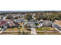 Wide shot of the house and surrounding neighborhood from above at 36628 Grand Island Oaks Cir, Grand Island, FL 32735