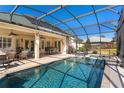 Inviting pool and spa with covered patio at 39248 Tacoma Dr, Lady Lake, FL 32159