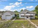 Quaint house exterior with attached garage and manicured lawn at 39645 Turek Ln, Umatilla, FL 32784