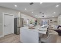 Modern kitchen with white cabinets, stainless steel appliances, and an island at 460 Brook Ridge Cir, Minneola, FL 34715