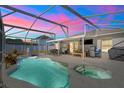 Relaxing pool and spa area with covered patio and outdoor kitchen at 460 Brook Ridge Cir, Minneola, FL 34715