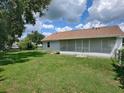 Large backyard with screened patio and grassy area at 51 Cr 532B, Bushnell, FL 33513