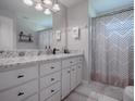 Bathroom boasts granite countertop, double vanity, and shower at 51 Cr 532B, Bushnell, FL 33513