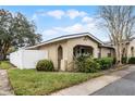 Side view of a house with a white fence and a grassy yard at 548 Cascade Cir # 100, Casselberry, FL 32707