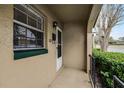 Front entrance with a white door and green trim at 548 Cascade Cir # 100, Casselberry, FL 32707