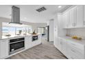 Modern kitchen with white cabinets, island, and stainless steel appliances at 5526 Parkdale Dr, Orlando, FL 32839