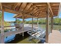 A well-maintained dock features a covered area, a boat lift, and tranquil water views for outdoor enjoyment at 6026 Landings Blvd, Lady Lake, FL 32159