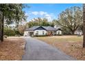 Long paved driveway leading to a charming house at 6832 Maryland Ave, Groveland, FL 34736