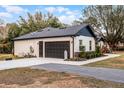 Two car garage with extra storage space and concrete driveway at 6832 Maryland Ave, Groveland, FL 34736