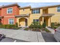 Two-story townhome with attractive landscaping and inviting entryway at 8955 Coco Palm Rd, Kissimmee, FL 34747